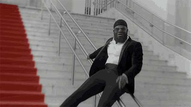 a man in a tuxedo is sitting on the stairs