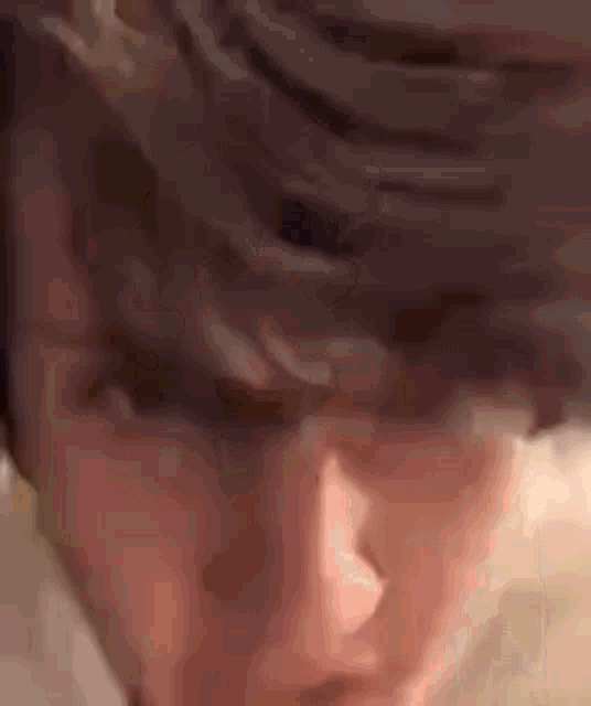 a close up of a person 's face with their eyes closed and their mouth open .