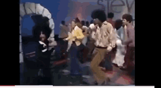 a group of people dancing in front of a sign that says stev
