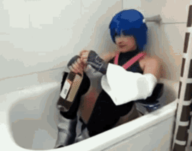 a person in a bathtub with a bottle of alcohol