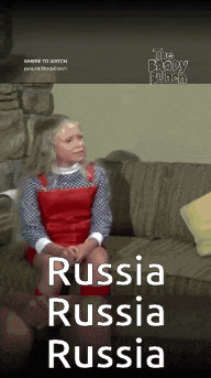 a woman is sitting on a couch with the words " russia russia russia " on the bottom