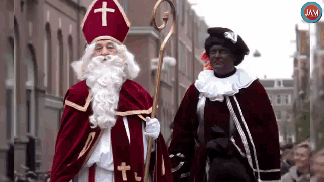a man dressed as santa claus and a black man dressed as sinterklaas