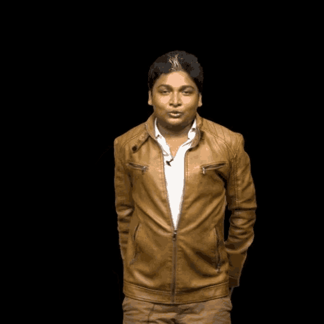 a man wearing a brown leather jacket and a white shirt