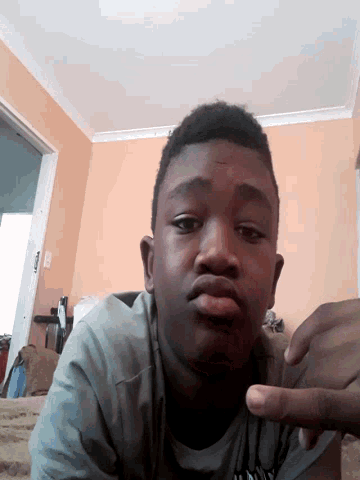 a young man taking a selfie in a room
