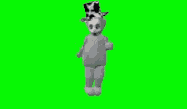 a teletubbies character wearing a top hat is dancing on a green screen .