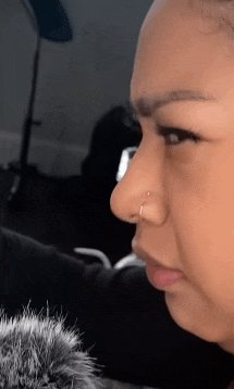 a close up of a woman 's nose with a ring in it