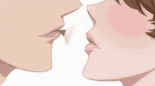 a man and a woman are kissing with a flower in between their lips .