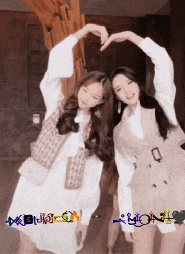 two women are making a heart shape with their hands and the word mon is on the bottom right