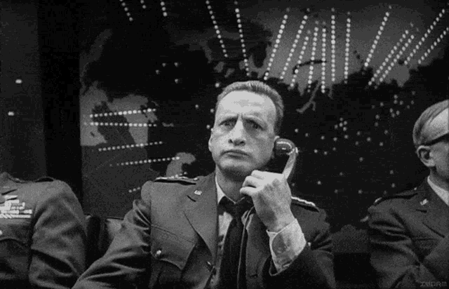 a man in a suit is talking on a phone