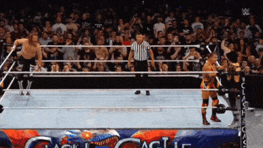 a referee stands in the middle of a wrestling ring with the word prime on the side
