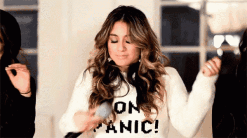 a woman wearing a sweater that says on panic is dancing