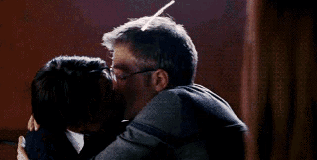 a man and woman are kissing with a heart drawn around them