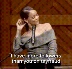 a woman is talking into a microphone and says " i have more followers than you oh tay fraud "