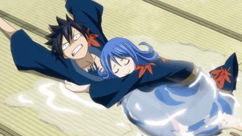 a man and a girl are laying on the floor and the girl is laying on the man 's lap