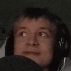 a man wearing headphones is making a funny face .