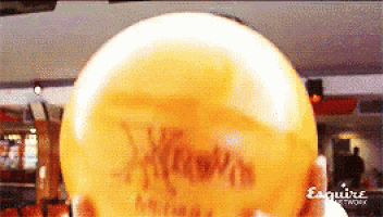 a bowling ball with esquire network written on the bottom right