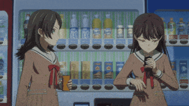 two girls are standing in front of a vending machine that sells coca cola and pepsi