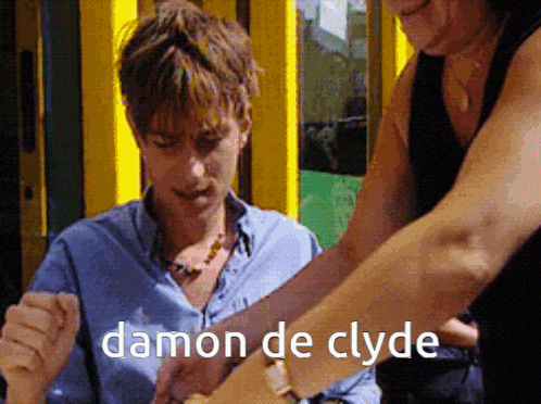 a man is being helped by a woman and the words damon de clyde are on the bottom