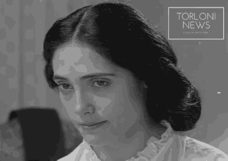 a black and white photo of a woman with the words torloni news on the bottom right