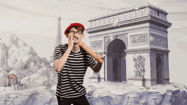a man wearing a red beret and a striped shirt holds a loaf of bread