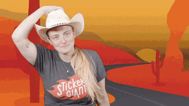 a woman in a cowboy hat is wearing a sticker giant t-shirt