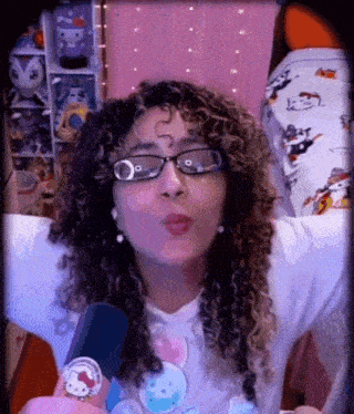 a woman wearing glasses and a hello kitty shirt