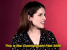 a woman is smiling with the words " this is like compliment fest 5000 " next to her