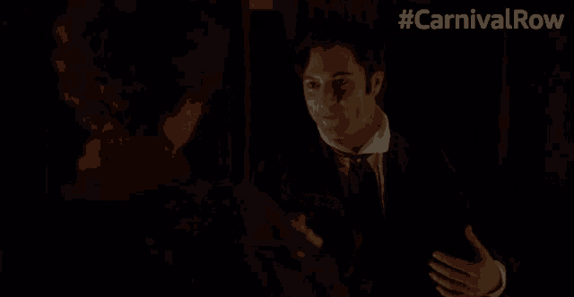 a man in a suit is talking to a woman in a clown costume with the hashtag #carnivalrow