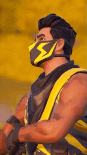 a man wearing a yellow and black mask with a lightning bolt on his face .