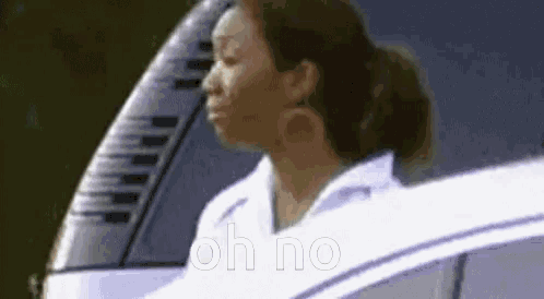 a woman is sitting in a car with her eyes closed and the words `` oh no '' written on the screen .