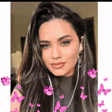 a woman wearing ear buds is surrounded by pink butterflies on a white background