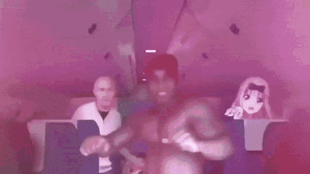 a man without a shirt is dancing on a plane while a woman in a mask looks on .