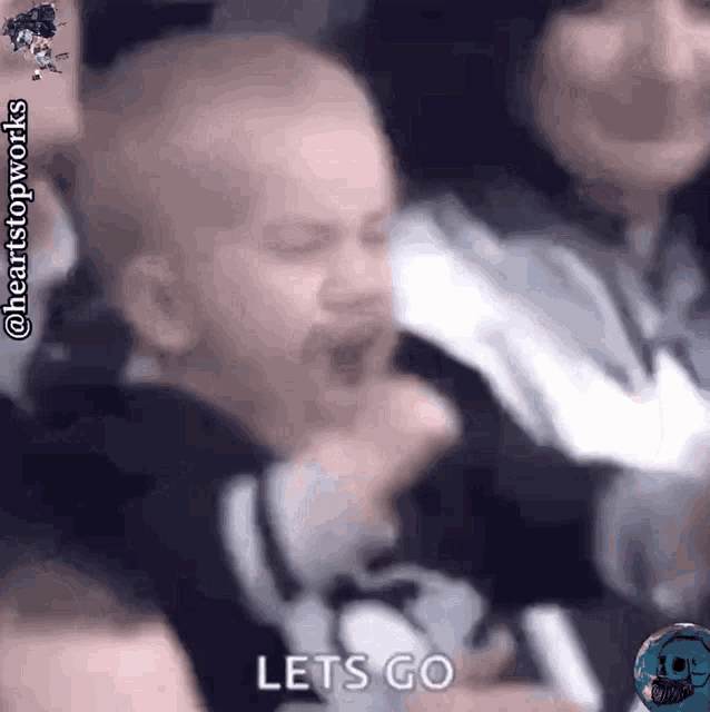 a baby in a crowd says let 's go in a blurry photo