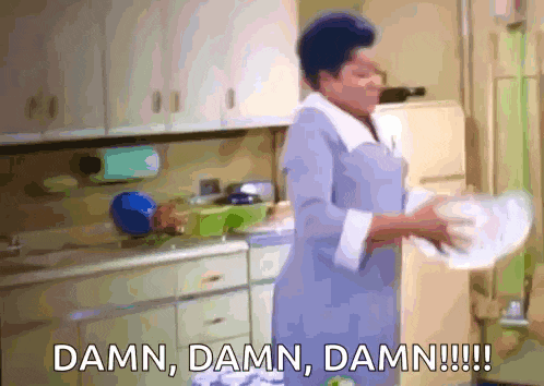 a woman is washing dishes in a kitchen and says damn damn damn