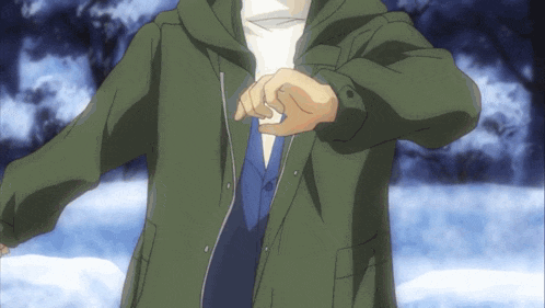 a man in a green jacket is standing in the snow looking at his watch