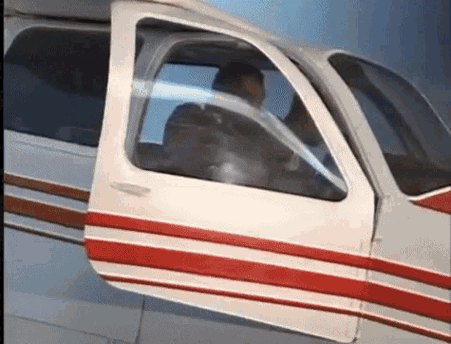 a man is sitting in the cockpit of a small plane