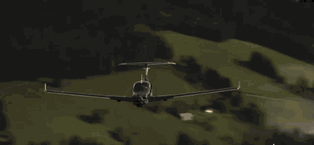 a plane is flying through a cloudy sky with a few trees in the background