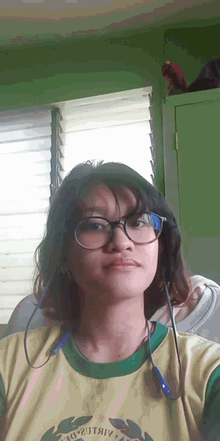 a girl wearing glasses and a yellow shirt that says 3g-201v