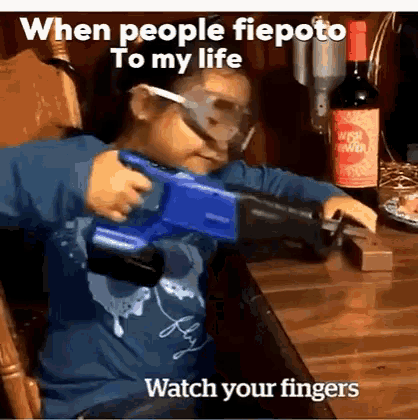 a little girl is holding a toy gun in front of a bottle of wine that says wish you were here