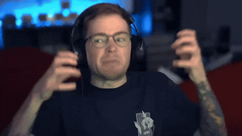 a man wearing headphones has a tattoo on his arm