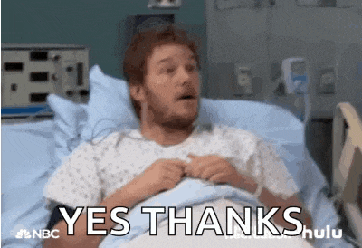 a man is laying in a hospital bed with the words yes thanks written above him .