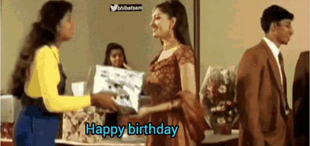 a woman giving a gift to another woman with the words happy birthday