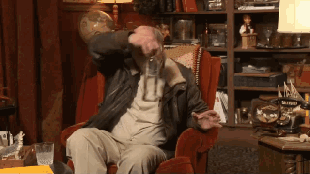 a man is sitting in a chair with a telephone that says ' smith ' on it