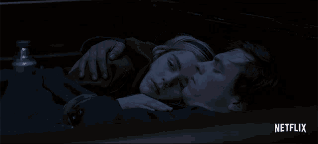 a man and a woman are laying in a car with netflix written on the bottom