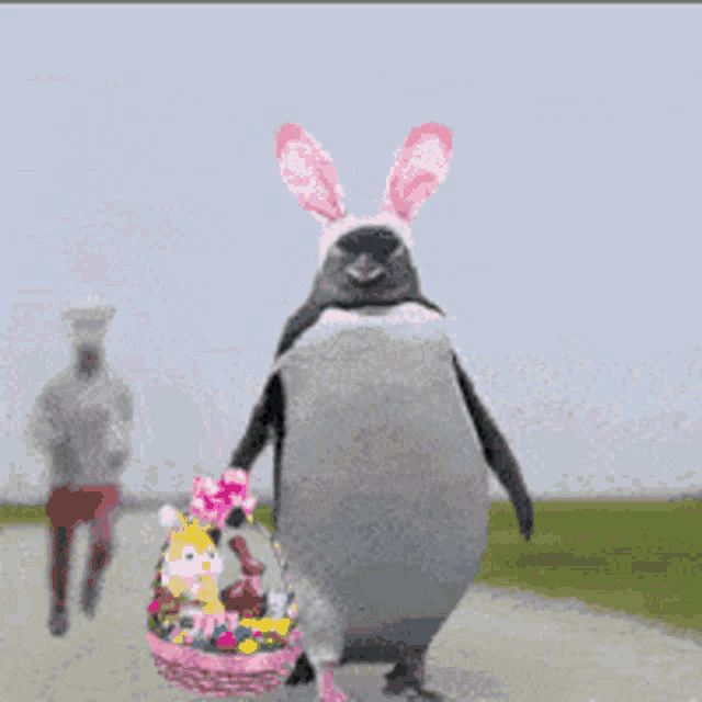 a penguin wearing bunny ears is carrying a basket of easter eggs
