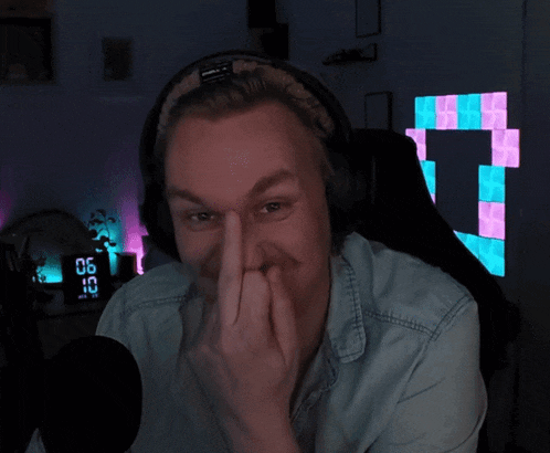 a man wearing headphones is giving the middle finger in front of a clock that says 6:32
