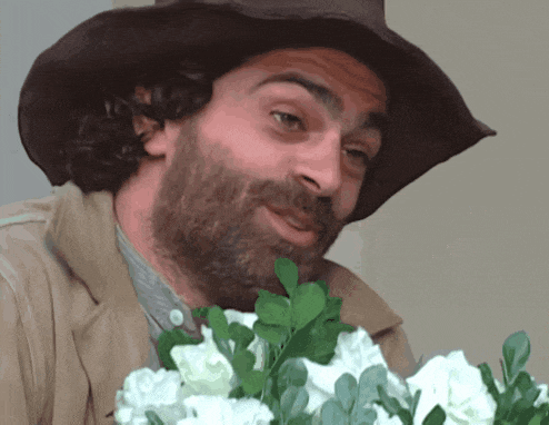 a man with a beard wearing a cowboy hat