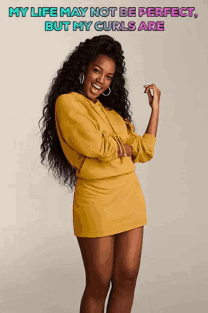 a woman in a yellow dress with the words " my life may not be perfect but my curls are " above her