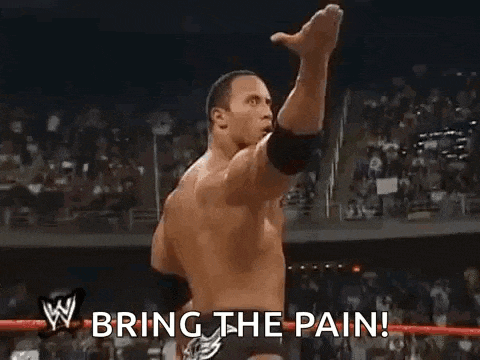 a wrestler is giving the middle finger in front of a crowd and says `` bring the pain '' .
