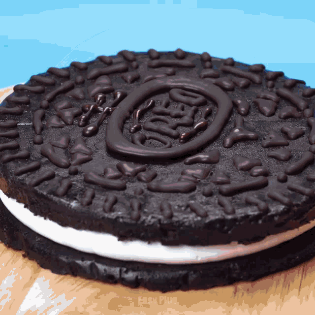 a cake that looks like an oreo cookie on a wooden table